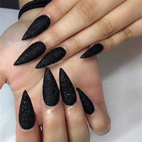 black glitter stiletto nails.